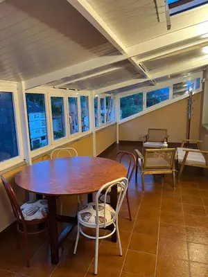 a dining room with a wooden table and chairs at Tres Ruas in A Pontenova