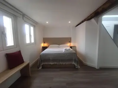 a bedroom with a bed and two windows at Lepanto 4 - Precioso y súper luminoso dúplex con vistas in Ourense