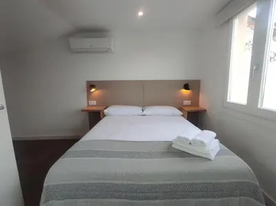 a bedroom with a bed with two towels on it at Lepanto 4 - Precioso y súper luminoso dúplex con vistas in Ourense