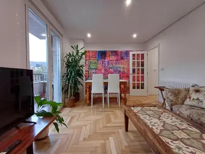 a living room with a table and a couch at La glorieta del Miño in Ourense