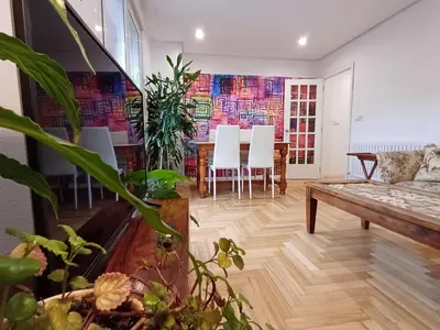 a living room with a couch and a table and chairs at La glorieta del Miño in Ourense