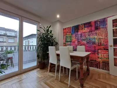 a dining room with a large painting on the wall at La glorieta del Miño in Ourense
