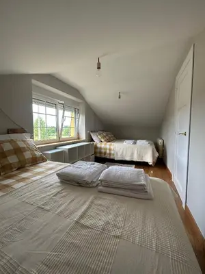 a bedroom with two beds and a large rug at El polvorín in El Franco