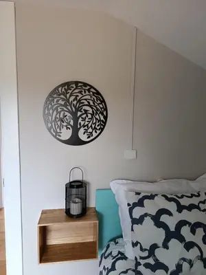 a bedroom with a tree stenciled on the wall at El polvorín in El Franco