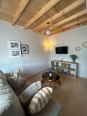 a living room with a couch and a table at El polvorín in El Franco