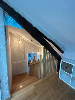 a living room with a wooden floor and a ceiling at El polvorín in El Franco