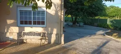 a bench sitting in front of a building with a window at Lama de María in Ourense