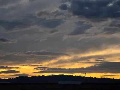 a cloudy sky with a sunset in the background at piso libertad in Ourense