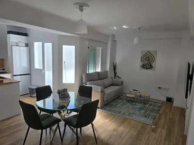 a living room with a glass table and chairs at piso libertad in Ourense