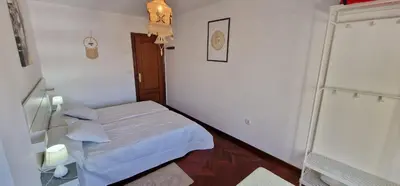 a small white room with a bed and a door at El Mirador de Covas - 2 Hab - Garaje in Covas