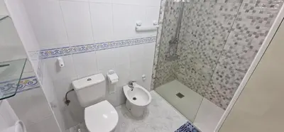 a white bathroom with a toilet and a shower at El Mirador de Covas - 2 Hab - Garaje in Covas