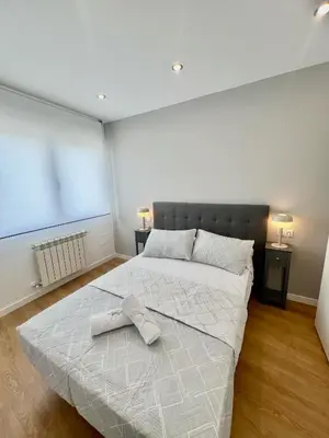 a bedroom with a bed with a towel on it at A Casa Riquiña in Lugo