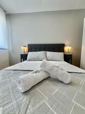 a bed with white towels laying on top of it at A Casa Riquiña in Lugo