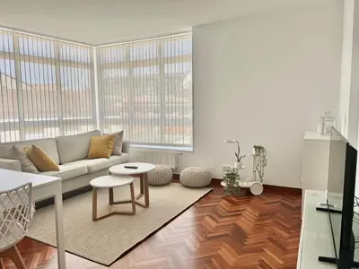 a living room with a couch and a table at Abaleen apartamento in Sigüeiro