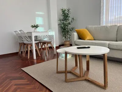 a living room with a couch and a table at Abaleen apartamento in Sigüeiro