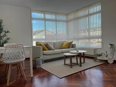 a living room with a couch and a table at Abaleen apartamento in Sigüeiro