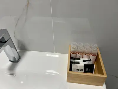 a box of toiletries sitting on top of a counter at Abaleen apartamento in Sigüeiro