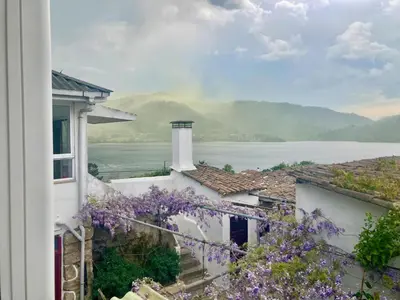 a view from a window of a house with purple flowers at Forxa, Ventosela in Ventosela