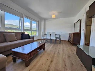 a living room with a couch and a table at Chalet con WIFI , PS4 , garaje, 5 dormitorios, 3 baños, Santiago de Compostela in Santiago de Compostela