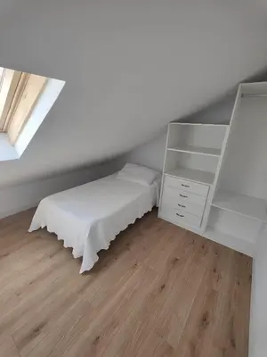 a bedroom with a bed and a white cabinet at Chalet con WIFI , PS4 , garaje, 5 dormitorios, 3 baños, Santiago de Compostela in Santiago de Compostela