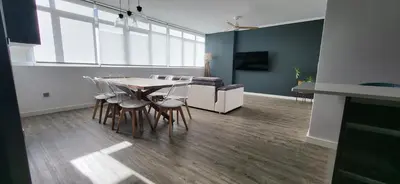 a living room with a table and chairs and a couch at Las Gaviotas in Viveiro