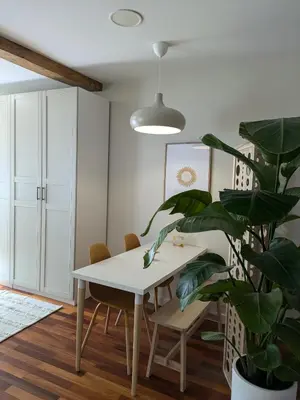 a dining room with a white table and a plant at La Mimosa in Puentedeume