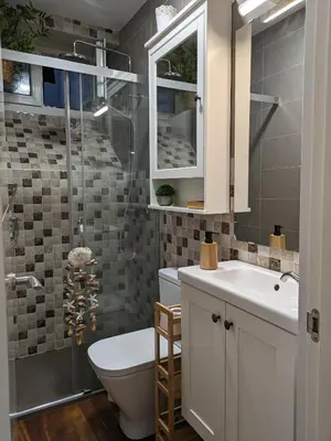 a bathroom with a toilet and a sink and a shower at La Mimosa in Puentedeume