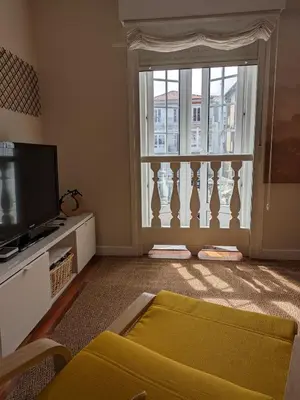 a living room with a tv and a window at La Mimosa in Puentedeume