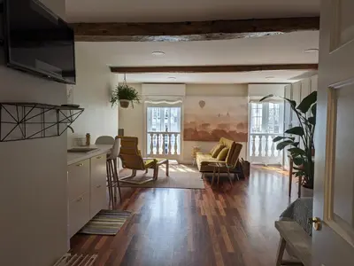a living room with a kitchen and a living room with a couch at La Mimosa in Puentedeume