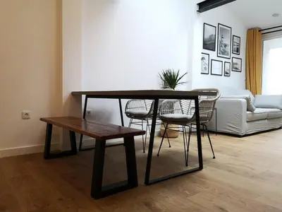 a living room with a table and chairs and a couch at Cabanela Maitia Jacuzzi privado y barbacoa in Ribadeo
