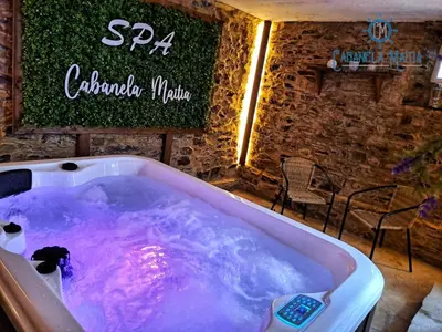 a jacuzzi tub in a restaurant with a sign at Cabanela Maitia Jacuzzi privado y barbacoa in Ribadeo