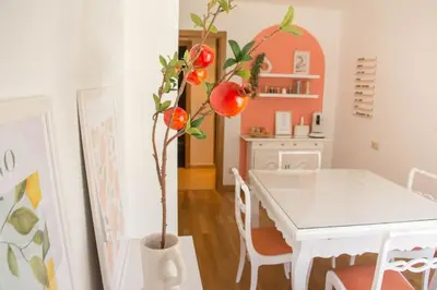 a dining room with a white table and a tree at Alojamiento YASA in Sarria