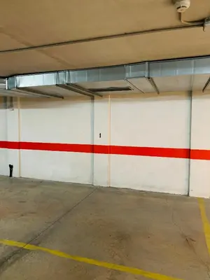 a garage with a red and white wall at Alojamiento YASA in Sarria