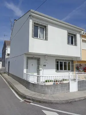 a white house on the side of a street at Casa Alise in Ribadeo
