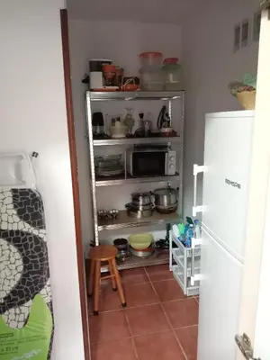 a small kitchen with a microwave and a refrigerator at Casa Alise in Ribadeo