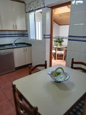 a kitchen with a table with a bowl on it at Casa Alise in Ribadeo