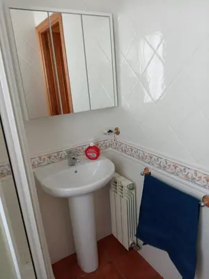 a bathroom with a sink and a mirror and a towel at Casa Alise in Ribadeo