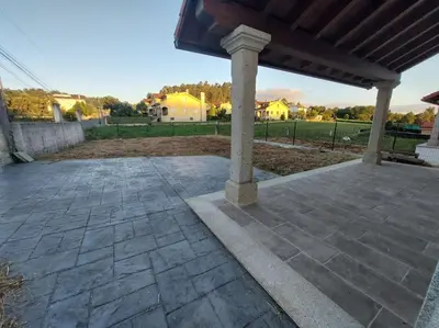 a stone patio with a pavilion in a yard at Casa Bela II in Sales