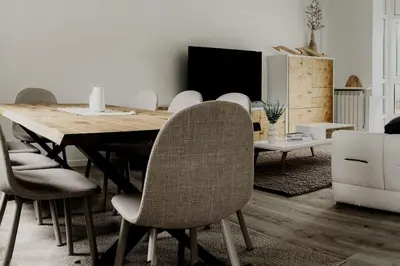 a dining room with a wooden table and chairs at Casa Bela II in Sales