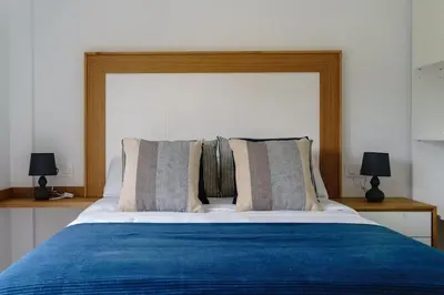 a bedroom with a blue bed with two lamps at Casa Bela II in Sales