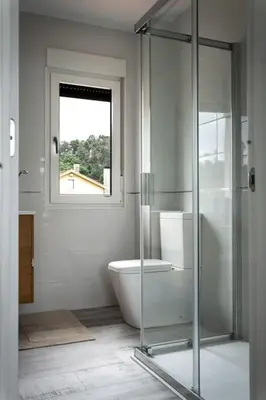 a bathroom with a glass shower and a toilet at Casa Bela II in Sales