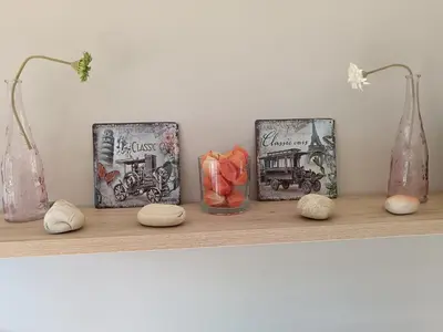 a shelf with three vases and rocks on it at Apartamento en Puerto de Vega in Navia