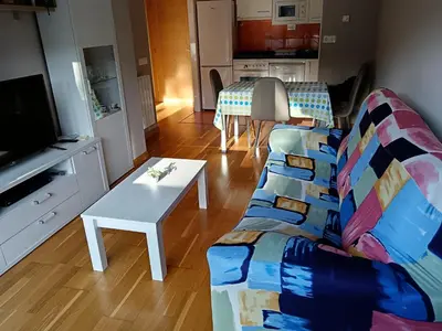 a living room with a couch and a table at Apartamento en Puerto de Vega in Navia