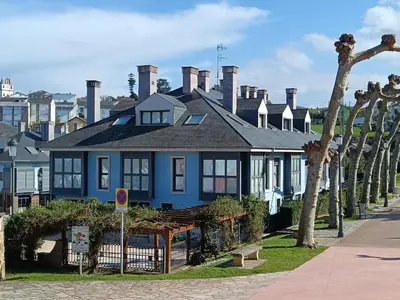 a blue house on the side of a street at Apartamento en Puerto de Vega in Navia