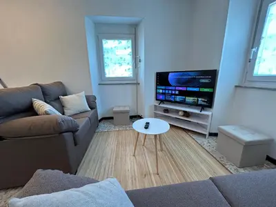 a living room with a couch and a tv at Casa Playa de Rueta in Cervo
