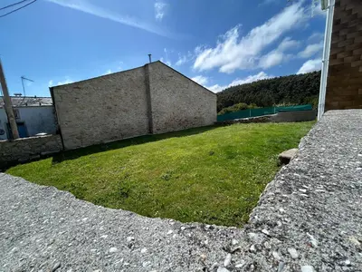 a building with a grassy yard next to a building at Casa Playa de Rueta in Cervo