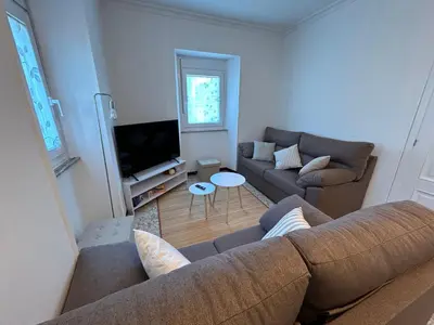 a living room with a couch and a tv at Casa Playa de Rueta in Cervo