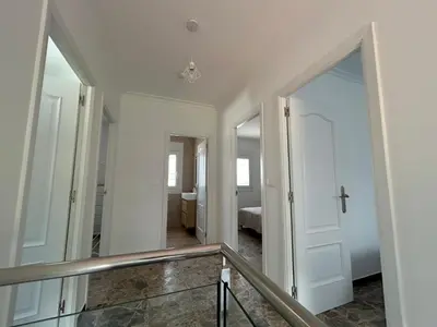 a hallway with a staircase leading to a bedroom at Casa Playa de Rueta in Cervo