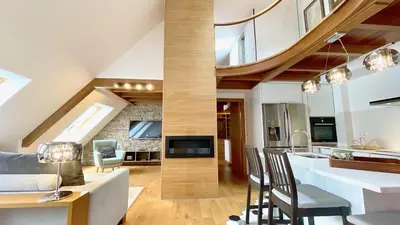 a kitchen and living room with a vaulted ceiling at The Cliffs - MarCastelos in Viveiro