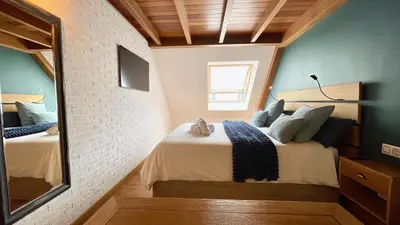 a bedroom with a bed and a mirror at The Cliffs - MarCastelos in Viveiro